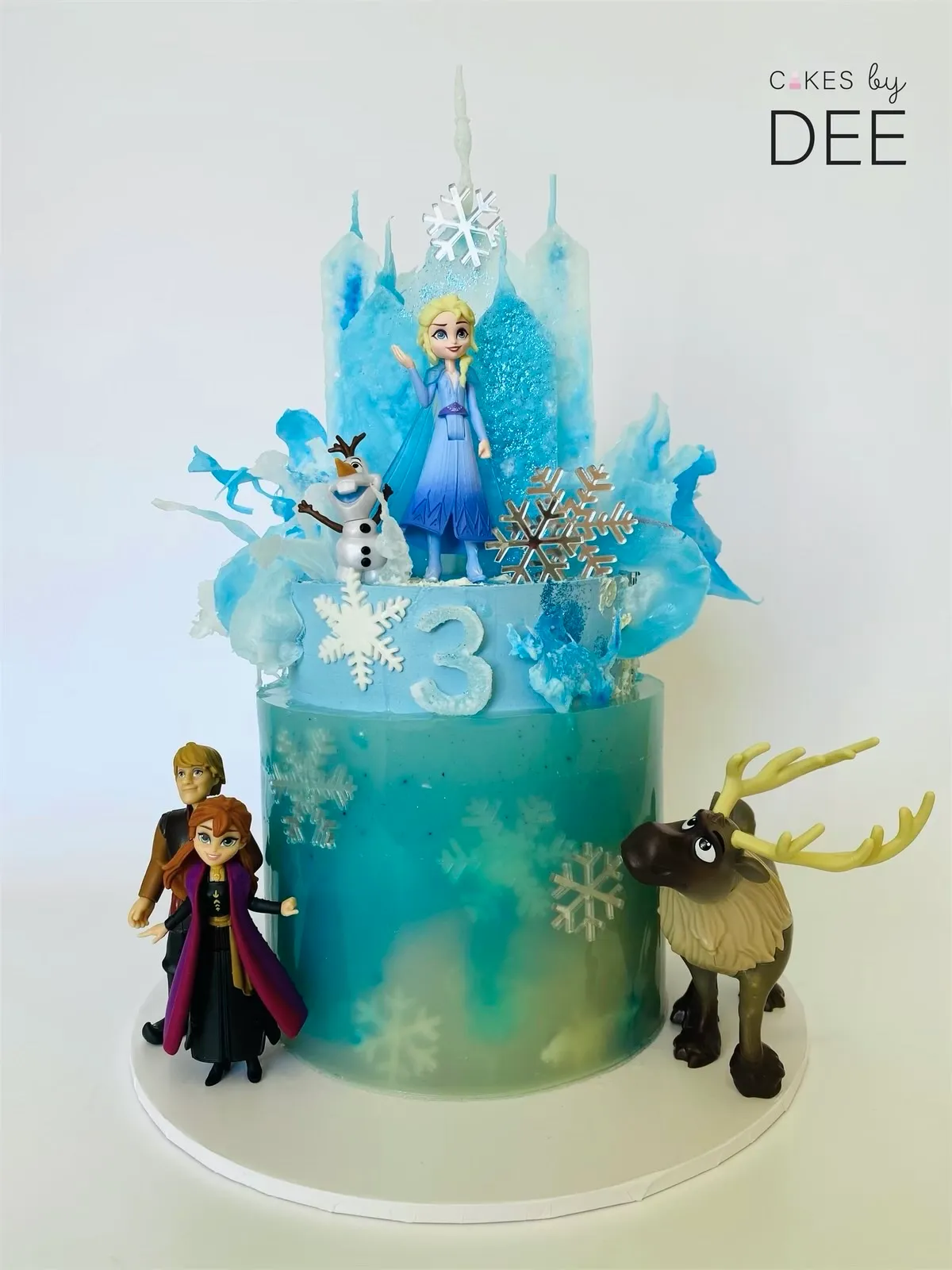 Frozen 3rd birthday cake with teal fondant, Elsa figurine, sculpted isomalt ice castle and snowflake decorations
